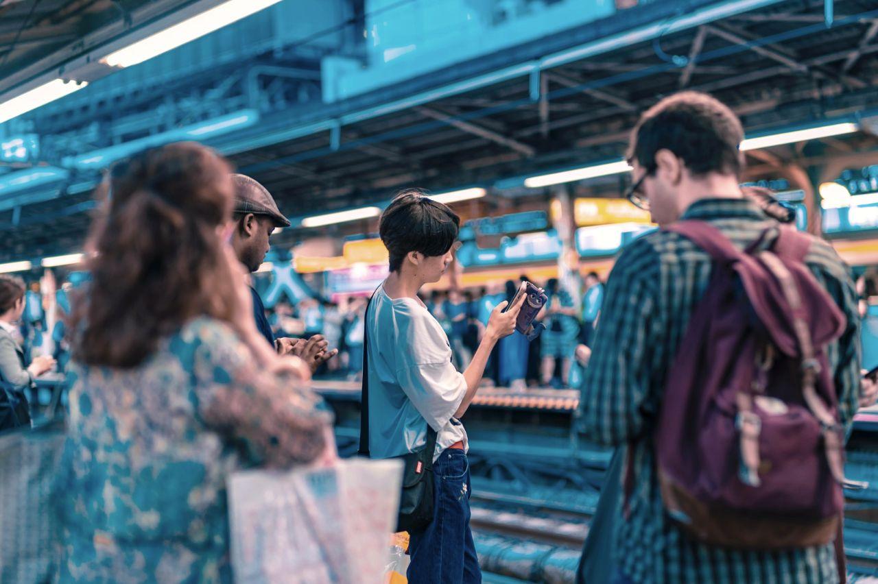 Using A Mobile Phone In A Train Station In Japan