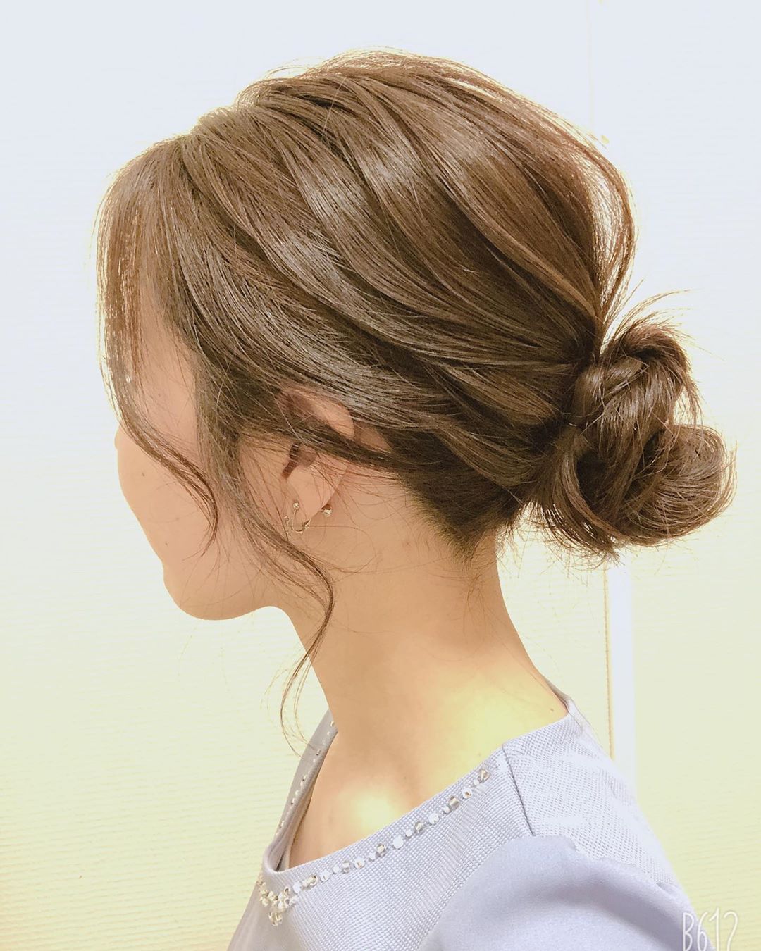 japanese hairstyles - textured messy bun with long side fringe side view