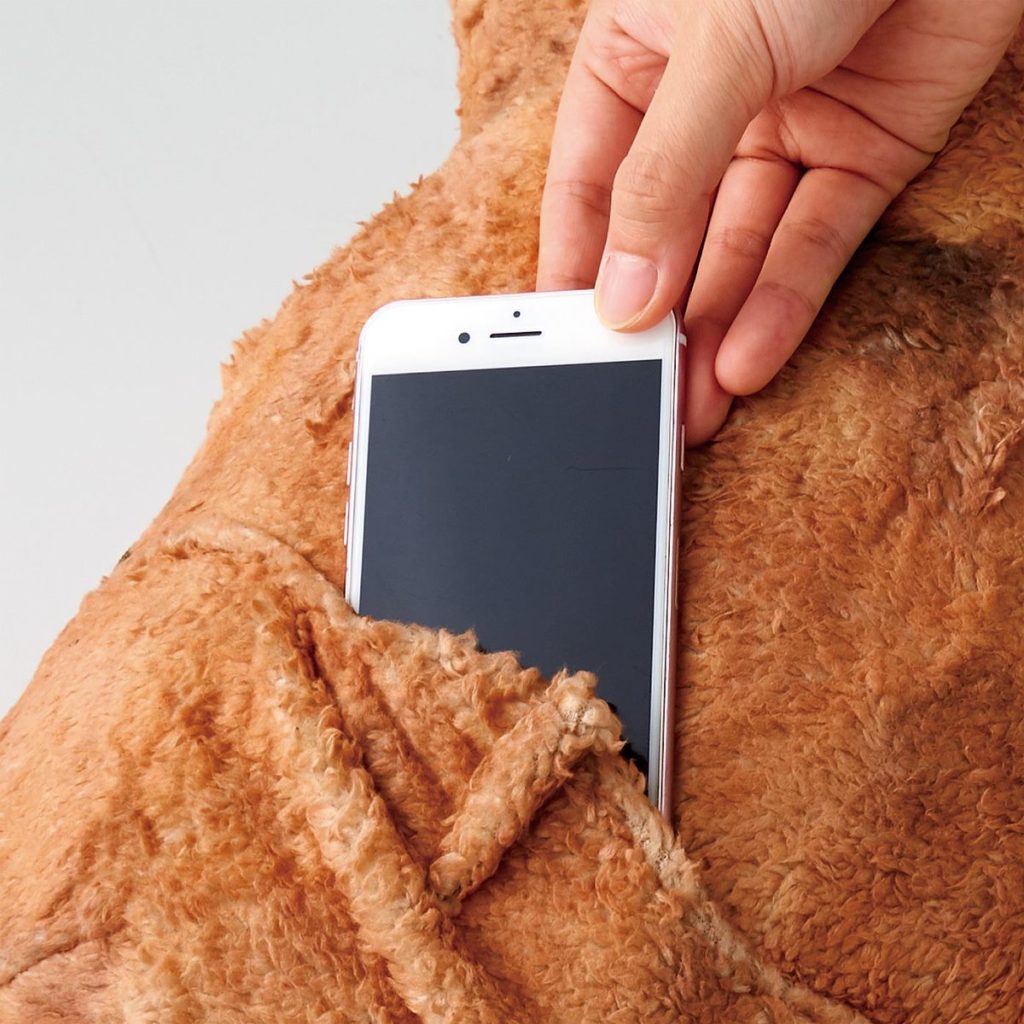 Felissimo’s karaage cushions - sliding a smartphone into the cushion's pocket
