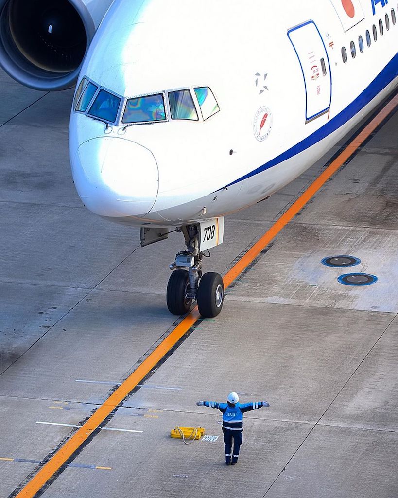 Transportation in Japan - staff directing the plane