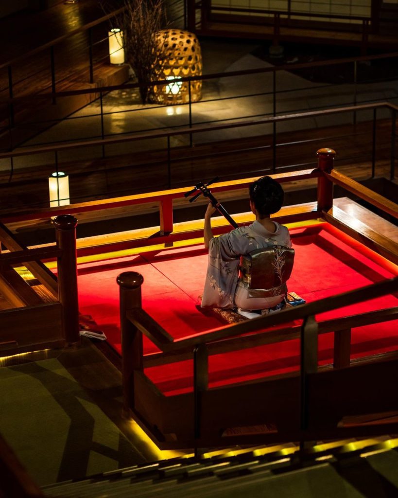 Demon Slayer Infinity Castle Ashinomaki Onsen Ookawaso - shamisen performance at the floating stage