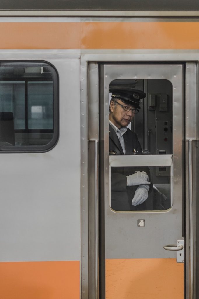 Japan travel tips - train conductor checking watch