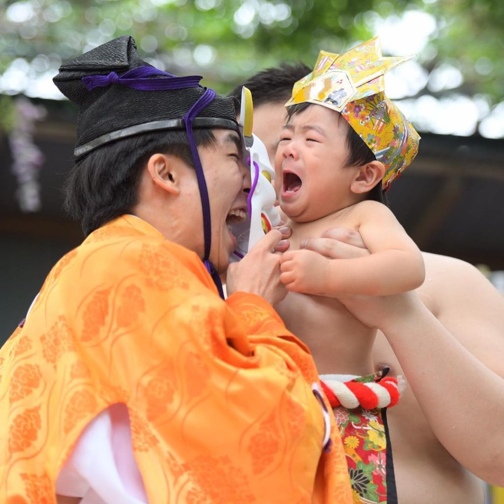 Naki Sumo Baby Crying Contest - shinto priest uses oni mask to tease baby