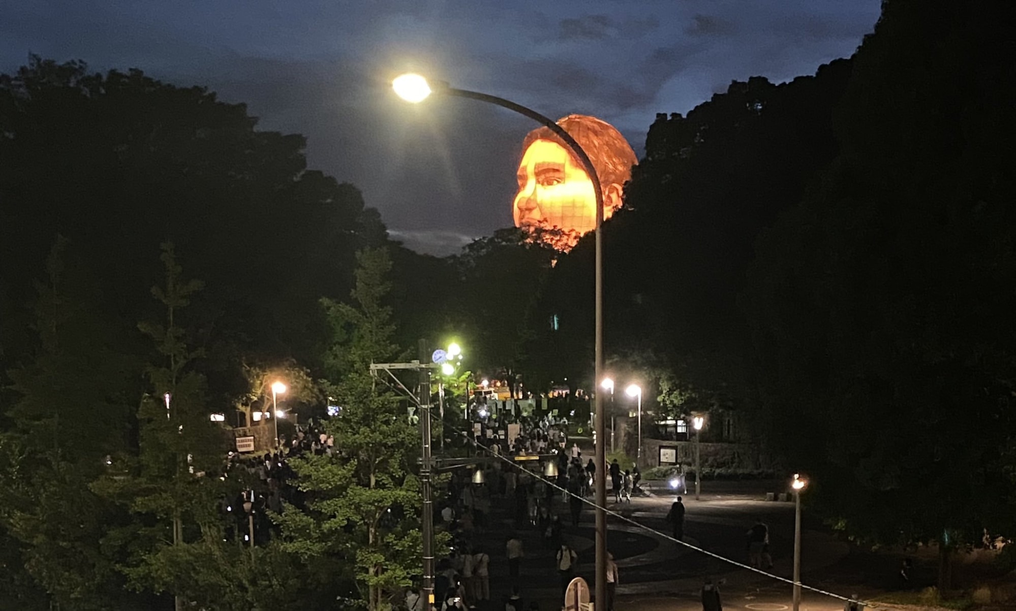 giant floating head at night