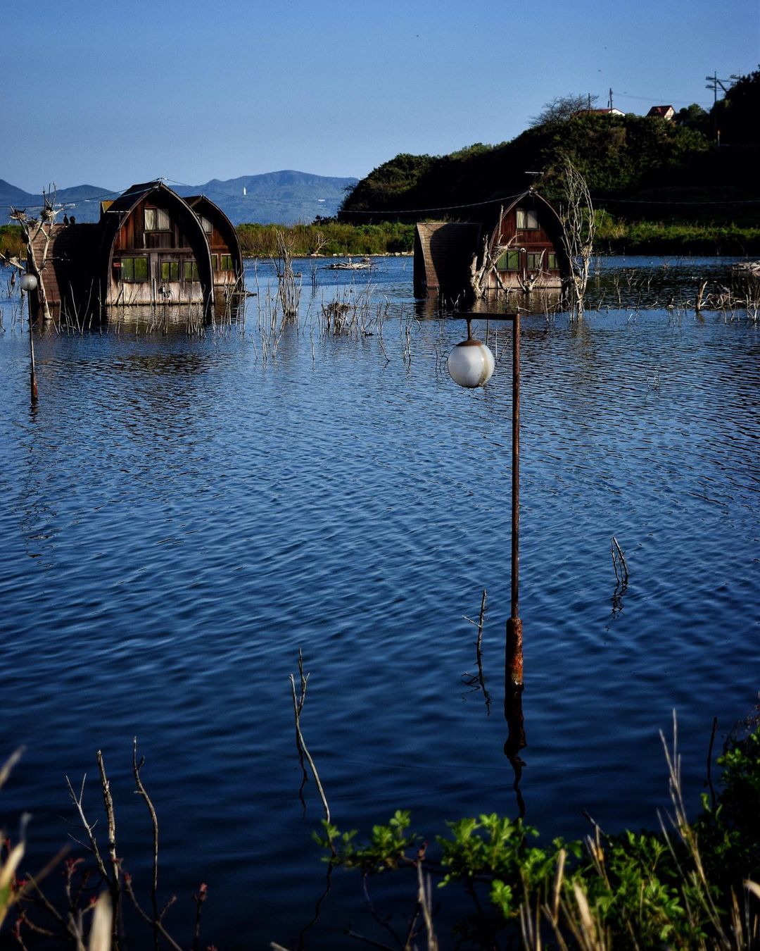 Ushimado Green Farm Ruins - rusty houses in a pool of water