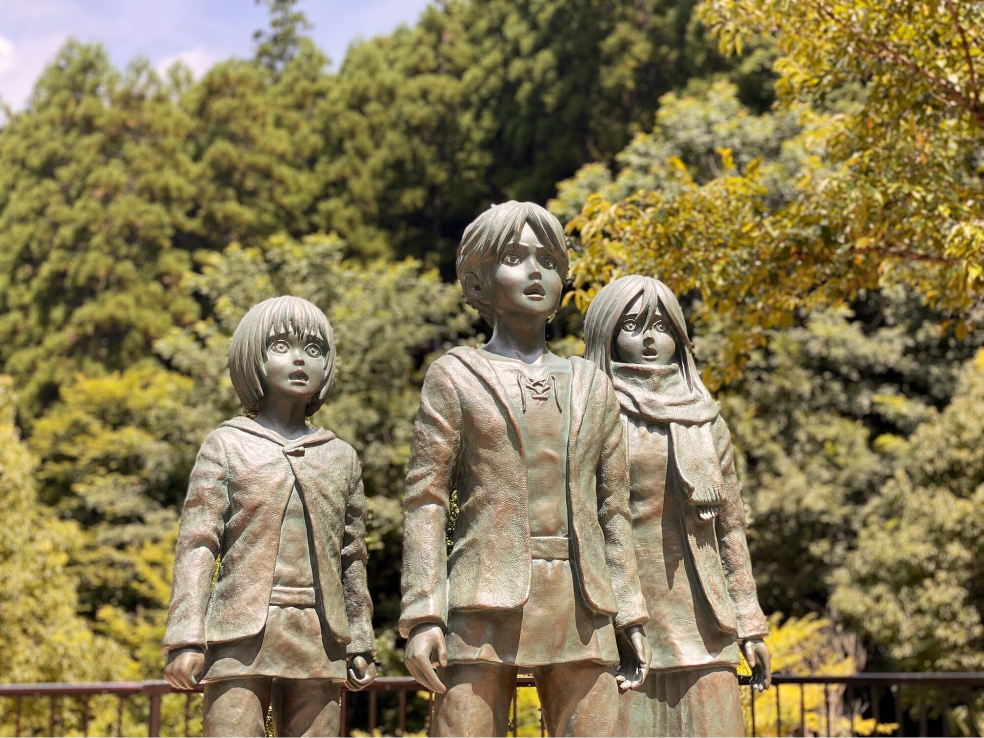 Attack on Titan in real life - statue of armin, eren, and mikasa