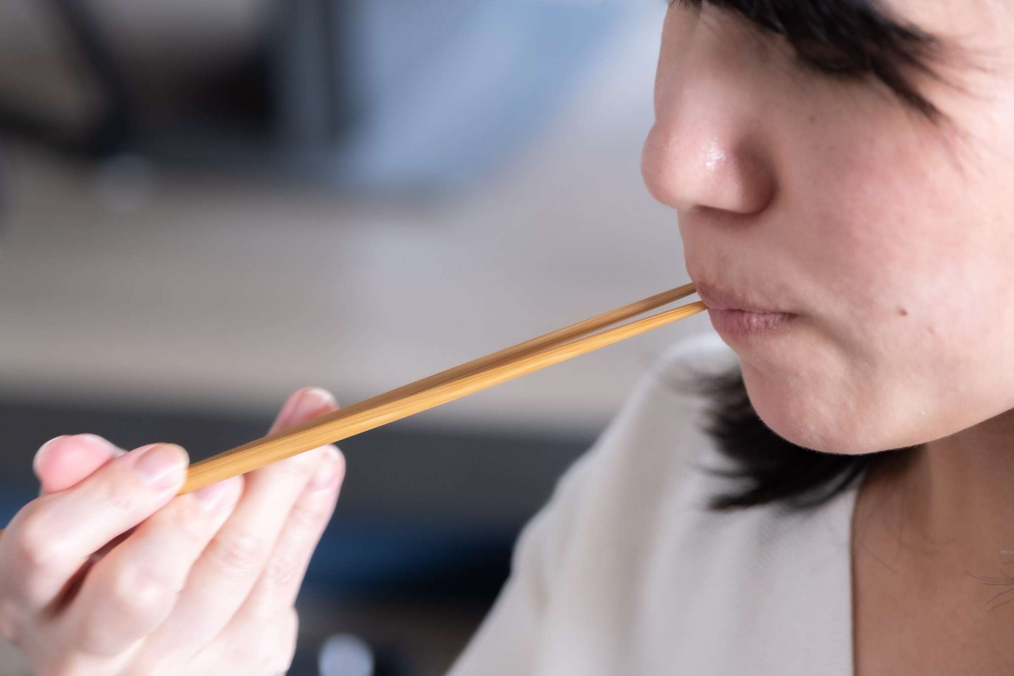 Chopsticks Taboos - woman licking chopsticks