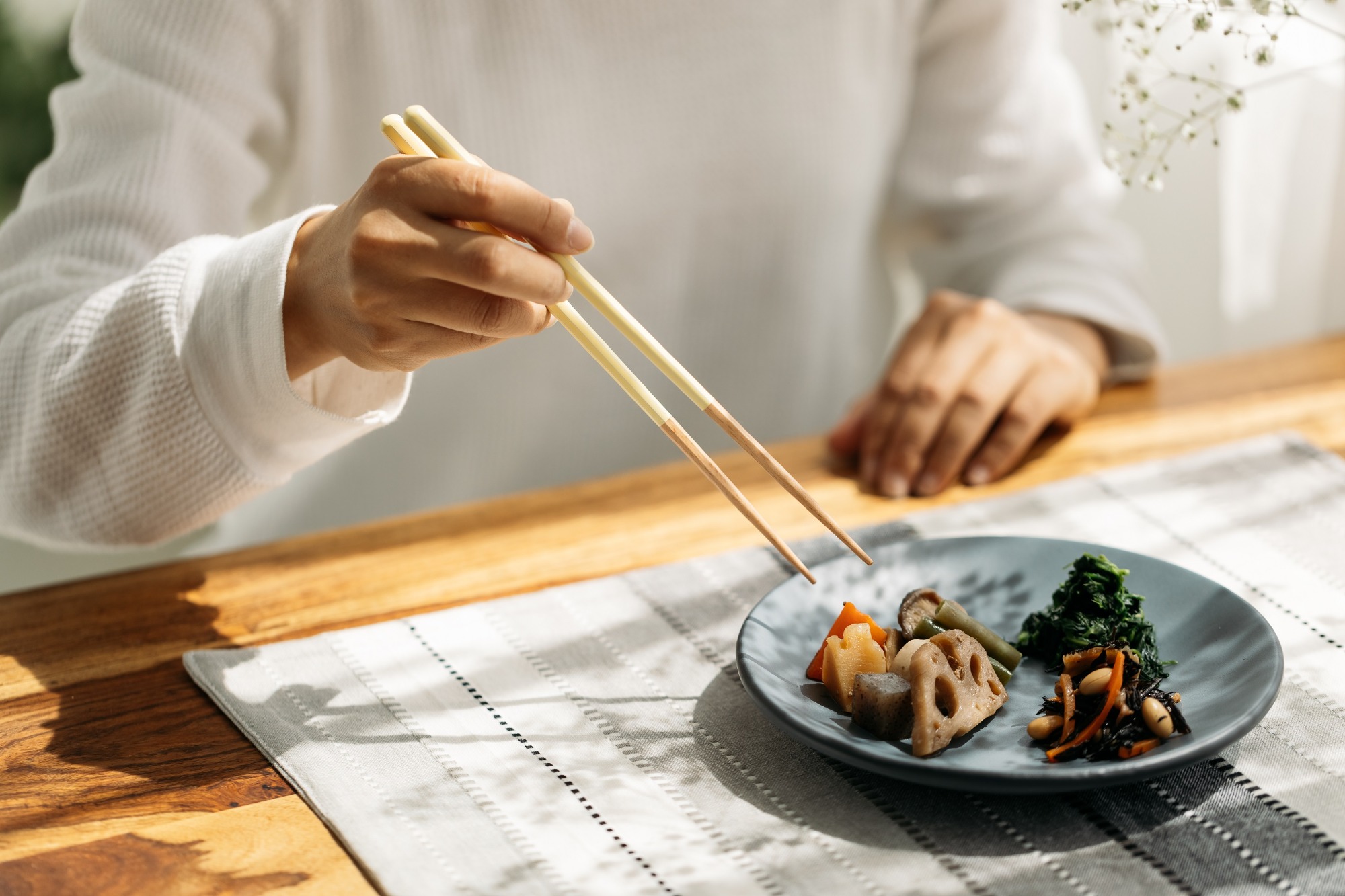 Chopsticks Taboos - person grabbing food with chopsticks