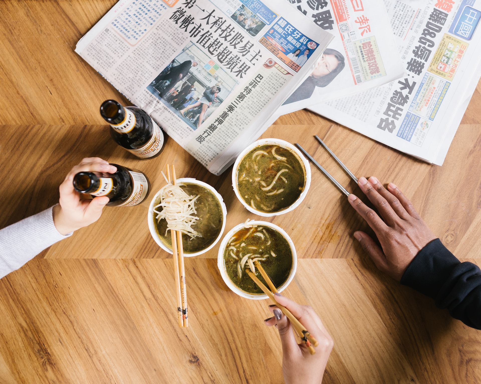 Chopsticks Taboos - people grabbing food with chopsticks