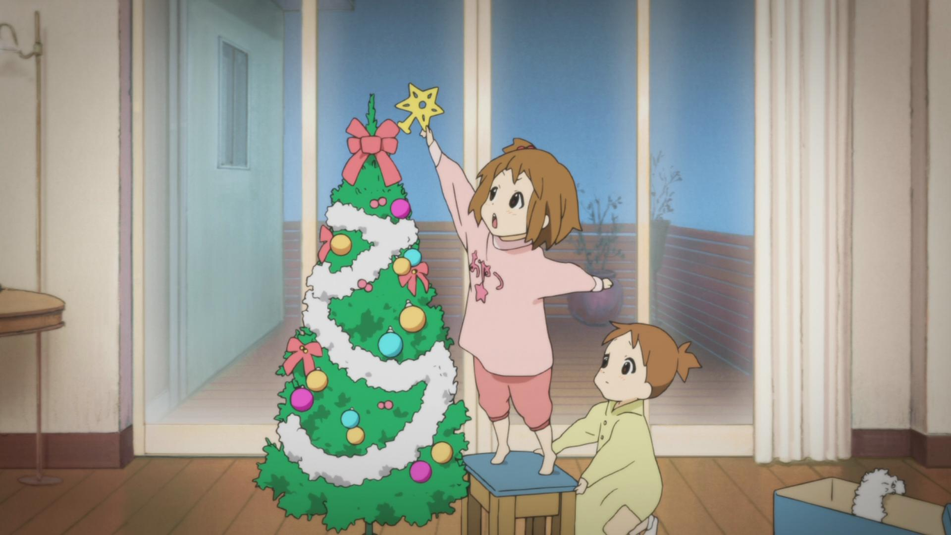 Christmas in Japan - child putting a star at the top of a Christmas tree