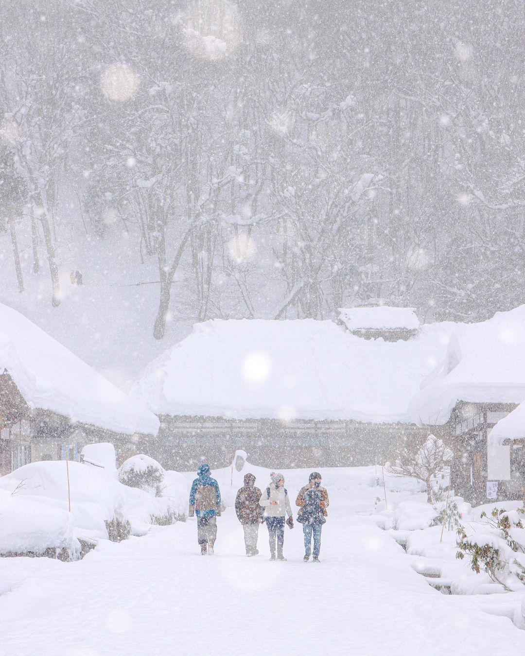 Cities in Japan to see snow - visitors walking in the snow in Ouchi-Juku