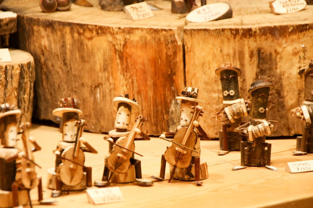 Cities in Japan to see snow - hand-crafted wooden figurines on sale at Ningle Terrace in Furano