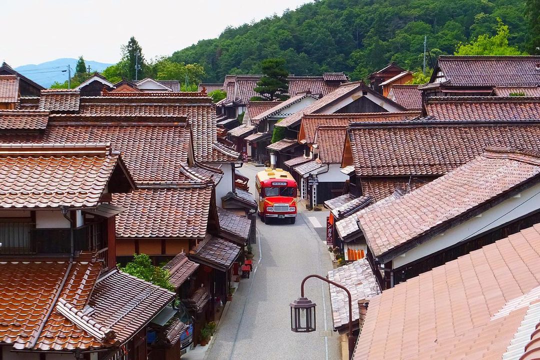 Fukiya Furusato Village - bird's eye view of buildings with sekishu-style roof tiles and bengara pigment