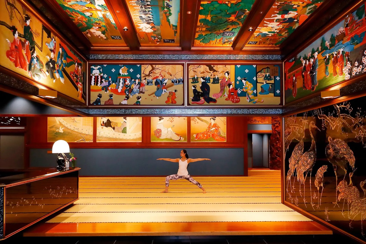 Hotel Gajoen Tokyo - person striking a yoga pose while surrounded by Japanese paintings