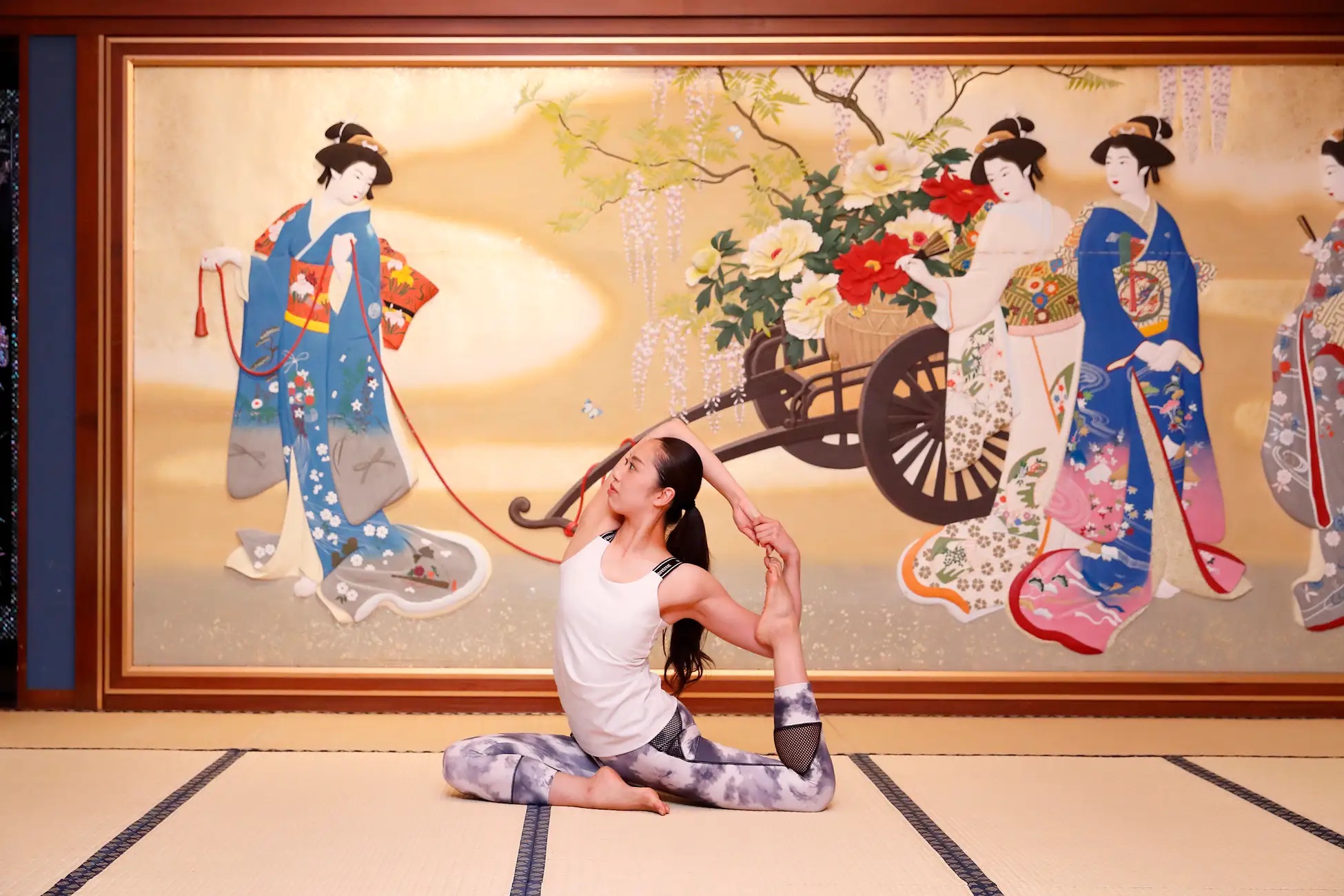 Hotel Gajoen Tokyo - person stretching in front of a landscape Japanese painting