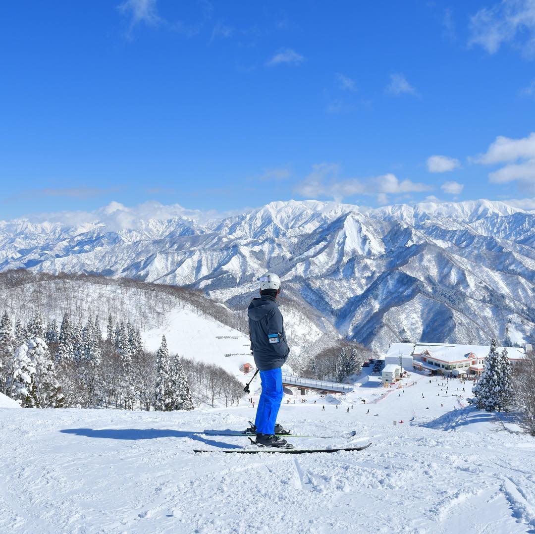 Japan ski resorts - person in ski gear admiring the view from GALA Yuzawa Snow Resort