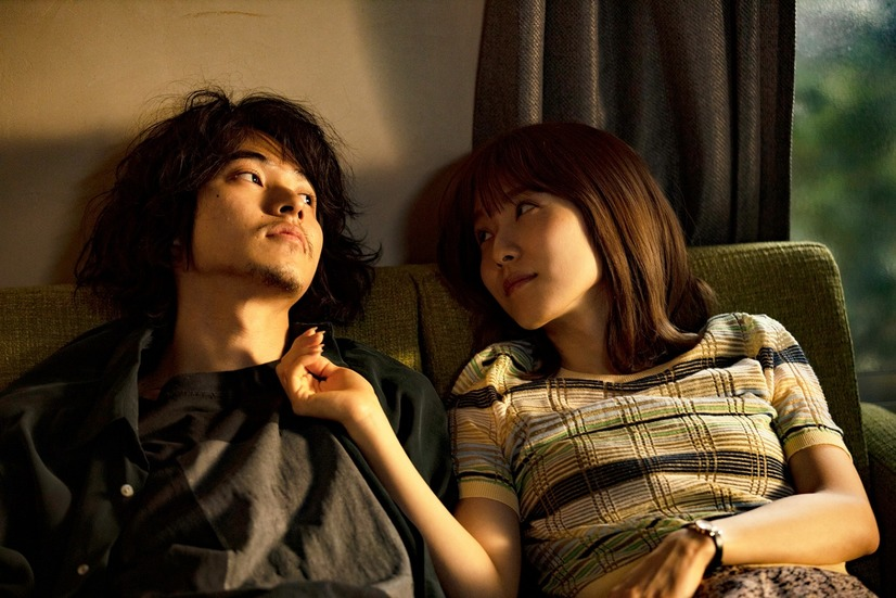 Japanese romance movies - Nagata and Saki looking at each other while sitting on the sofa